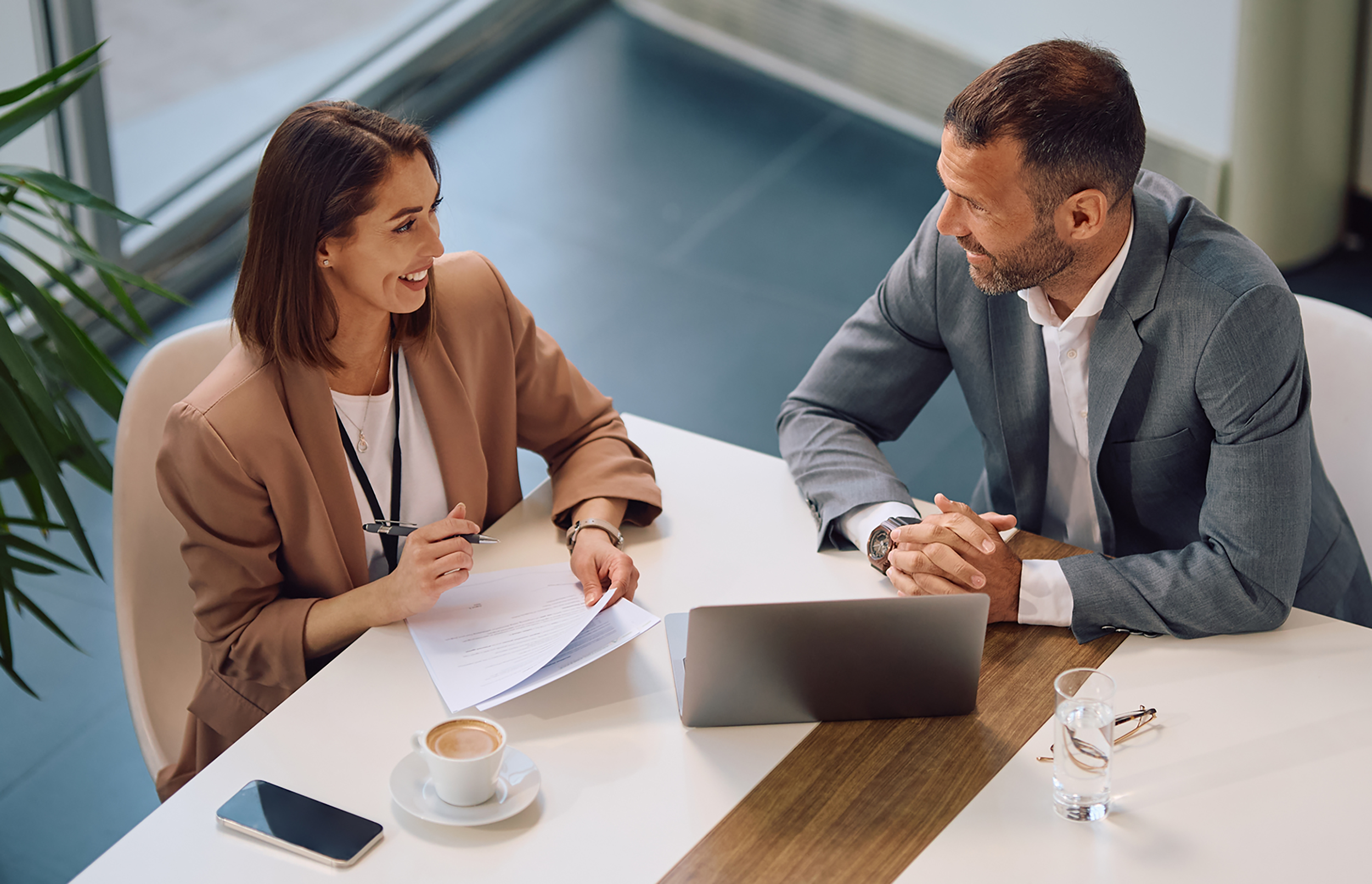 High,Angle,View,Of,Happy,Entrepreneur,And,Her,Colleague,Talking