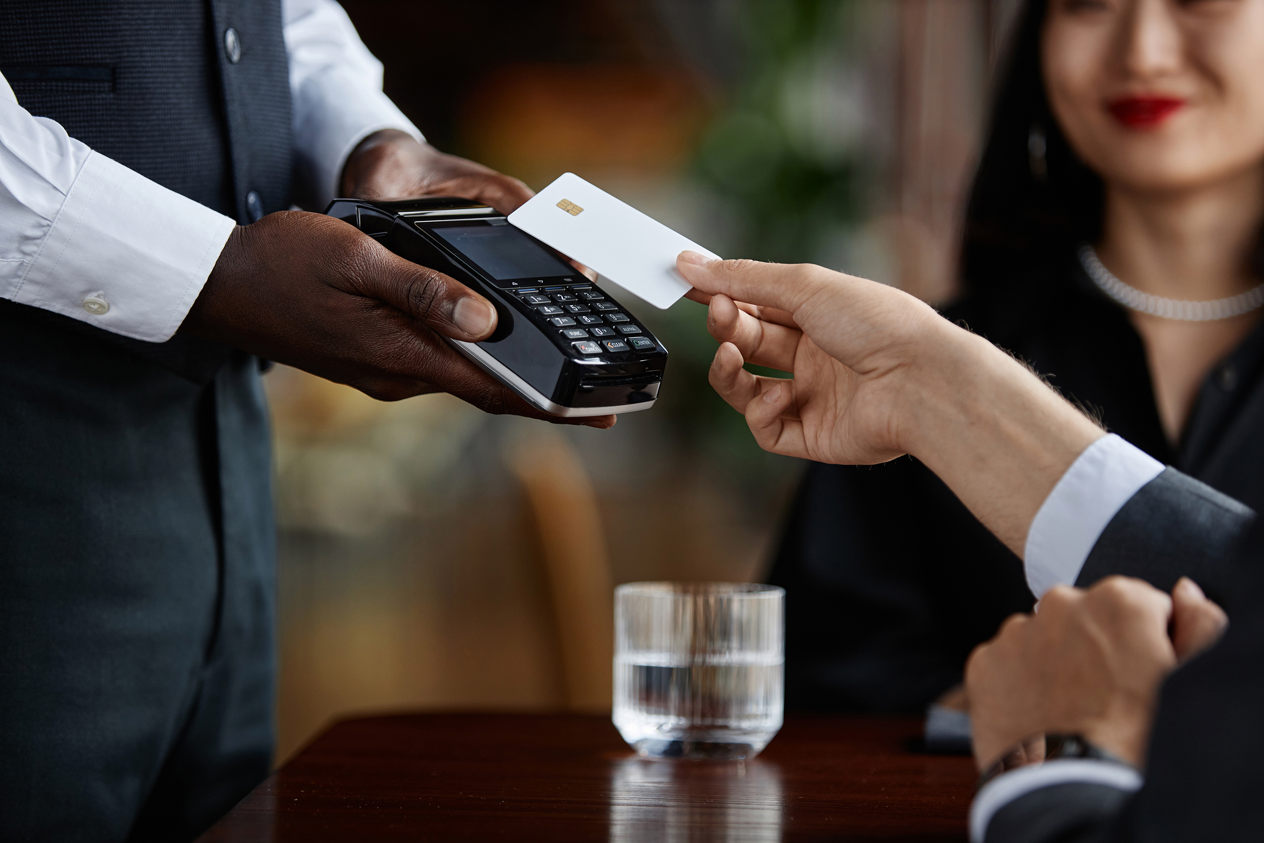 Side,View,Close,Up,Of,Guest,Paying,With,Credit,Card